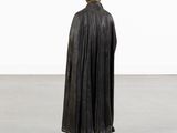 a statue of a man in a black cloak and hat