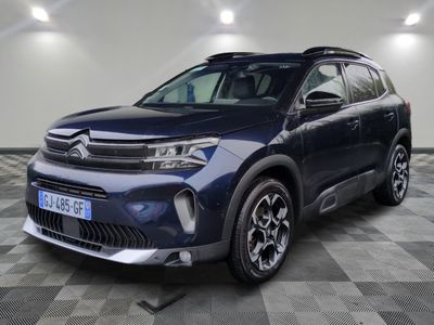 a blue suv parked in a garage with a checkered floor