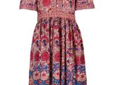 La robe est rose et bleue, avec un motif.