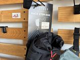 a bag hanging on the wall next to a pair of skis