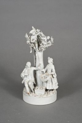 figurine of a man and a woman with a basket of flowers