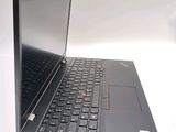 a laptop with a black keyboard on a white surface
