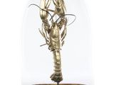 a close up of a statue of a lobster under a glass dome