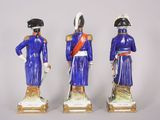 three figurines of men dressed in blue and white uniforms