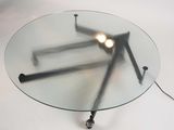 a glass table with a lamp on top of it