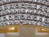 a close up of a diamond ring on a white surface