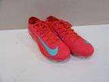 a pair of red and blue soccer shoes on a white surface