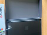 a laptop computer sitting on top of a desk next to a box
