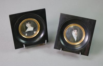 two framed pictures of a man and a woman on display