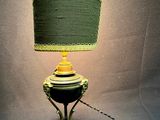 a lamp that has a green shade on top of it