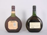 two bottles of liquor sitting next to each other on a white surface