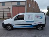 a white van parked in front of a building