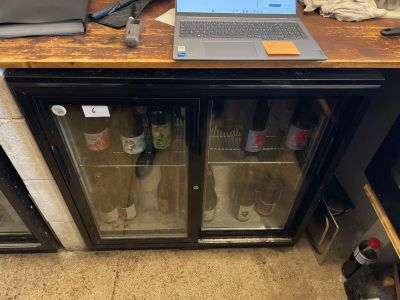a laptop computer sitting on top of a glass case