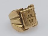 a close up of a gold ring on a white surface