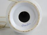 a close up of a white vase with a black hole in it