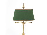 brass table lamp with a green shade on a white background