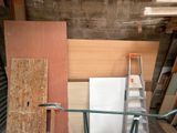 several pieces of wood are stacked on top of each other in a room
