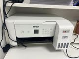 a printer sitting on top of a desk next to a printer
