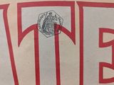 a paper bag with a red and white sign on it