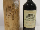 a bottle of wine sitting next to a box of wine