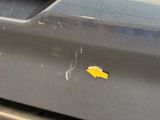 a yellow arrow on the side of a gray car