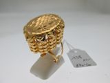 une image d'une bague en or sur une surface blanche avec une étiquette de prix
