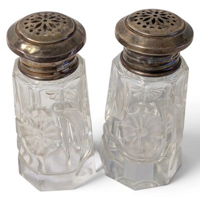 pair of clear glass salt and pepper shakers with metal tops
