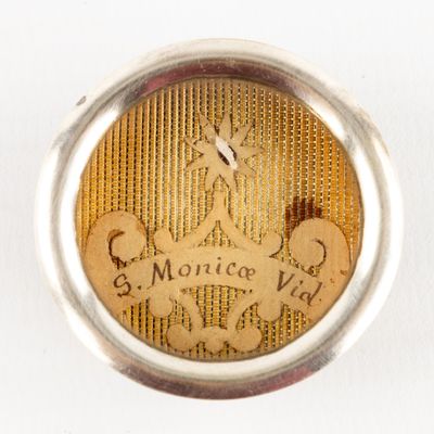 an image of a close up of a silver ring with a picture of a person on it