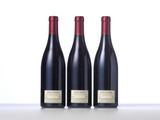 three bottles of wine sitting on top of a table