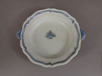 a blue and white plate with a tree on it