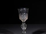 crystal goblet on a black table with a black background