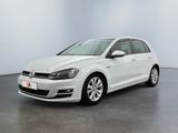 the white volkswagen golf is parked in a large room