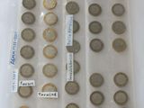 a lot of coins in a plastic bag on a table