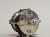 an image of a silver reel on a white surface