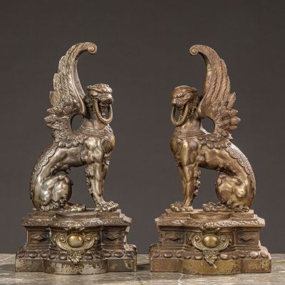 pair of antique bronze sculptures of a winged horse and a lion