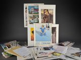 a pile of postcards sitting on top of a table