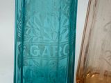 two glass bottles sitting next to each other on a table