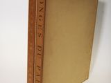 an old book sitting on top of a white table