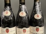 six bottles of wine are lined up on a table