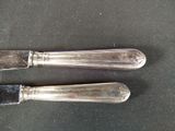 two knives that are sitting next to each other on a table