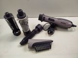 several different types of hair dryers and combs on a table