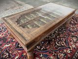 a coffee table with a glass top on a rug