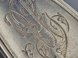 a silver spoon with a monogram on it