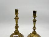 a pair of brass candlesticks on a white background