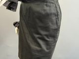 an image of a mannequin wearing a gray dress with a bow on it