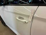 a white car with a sticker on the side of it ' s door