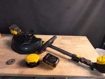 yellow and black tools sitting on top of a wooden table