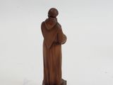 figurine of a monk holding a cross on a white background