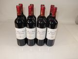 four bottles of wine are lined up on a counter