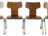 four wooden chairs are lined up in a row on a white background